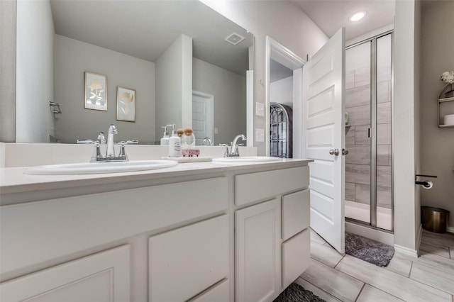 bathroom with vanity and a shower with shower door