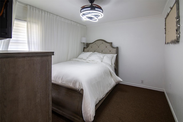 bedroom with crown molding and dark carpet