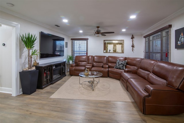 living room featuring light wood-type flooring and crown molding