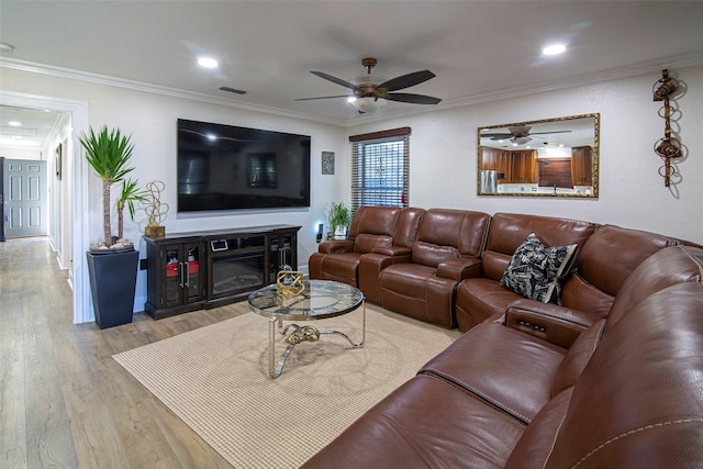 living room featuring light wood-type flooring and ornamental molding