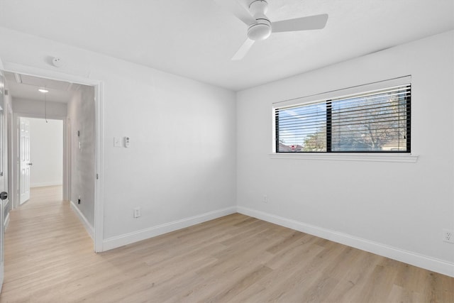 spare room featuring ceiling fan and light hardwood / wood-style flooring