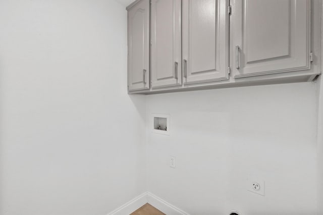 laundry area with cabinets, hookup for a washing machine, hookup for an electric dryer, and hardwood / wood-style floors