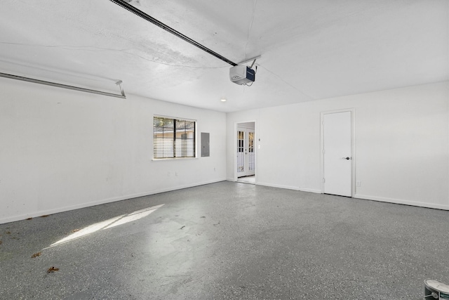 garage with electric panel and a garage door opener