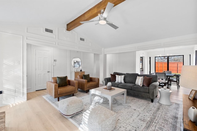 living room with lofted ceiling with beams, light wood-type flooring, and ceiling fan with notable chandelier