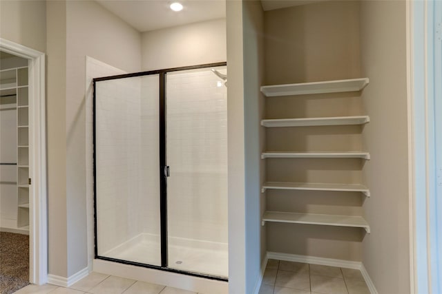 bathroom featuring tile patterned flooring and a shower with shower door