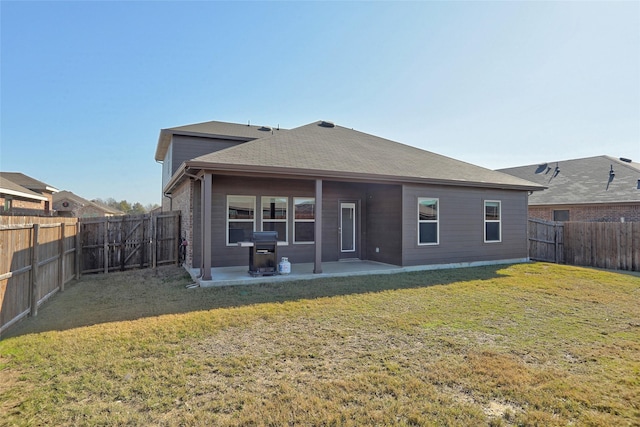 back of property featuring a patio area and a yard