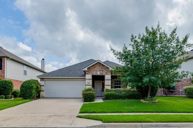 view of front of home with a garage and a front yard