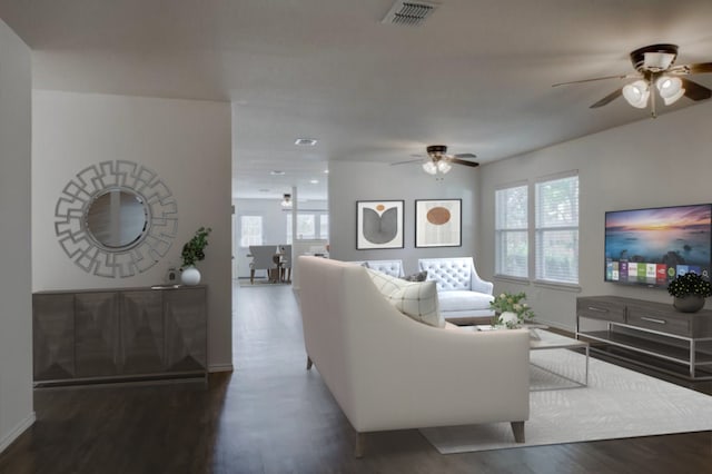 living room with dark hardwood / wood-style flooring and a healthy amount of sunlight