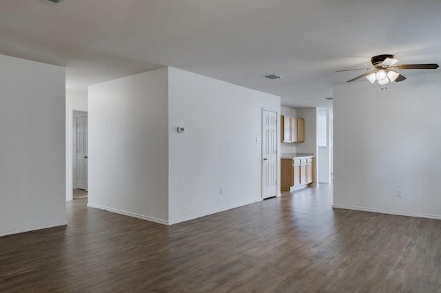 spare room featuring dark hardwood / wood-style floors and ceiling fan