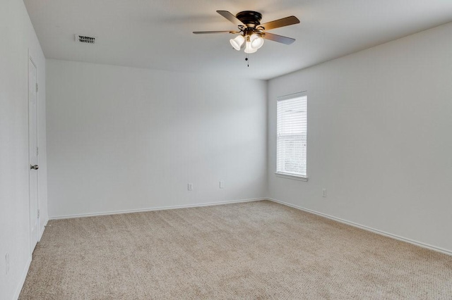 unfurnished room with ceiling fan and light carpet