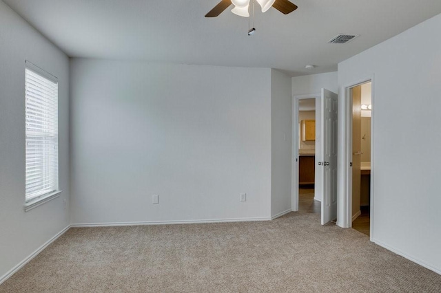 carpeted spare room with ceiling fan