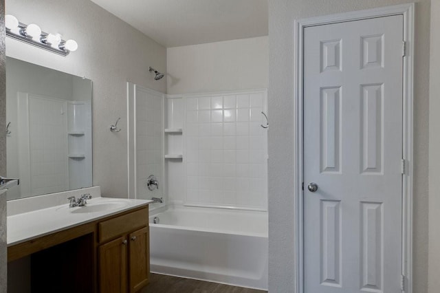 bathroom with shower / bathing tub combination, hardwood / wood-style floors, and vanity