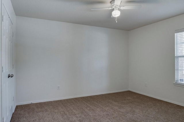 carpeted empty room featuring ceiling fan