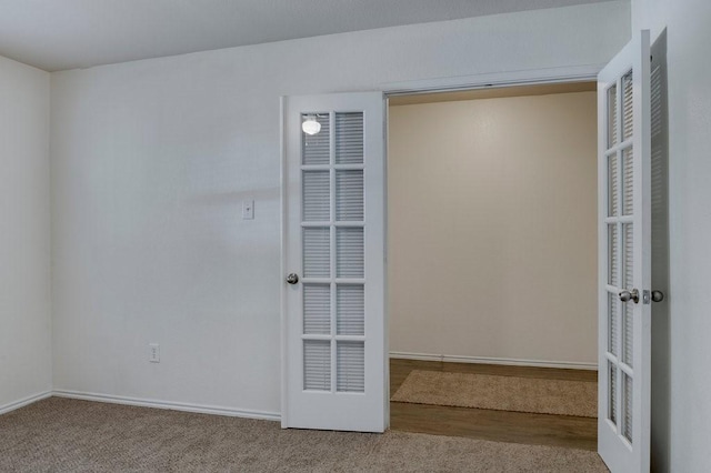 unfurnished room featuring carpet and french doors