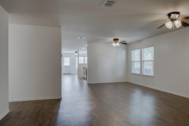 empty room with dark hardwood / wood-style floors and ceiling fan