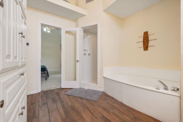 bathroom with wood-type flooring and separate shower and tub