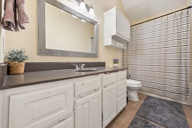 bathroom featuring tile patterned flooring, vanity, and toilet