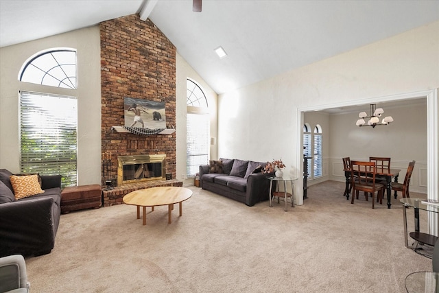 living room featuring beam ceiling, a healthy amount of sunlight, and light carpet