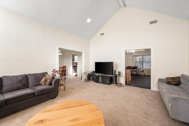 carpeted living room featuring beam ceiling, high vaulted ceiling, and a chandelier