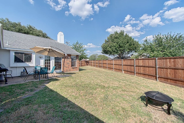 view of yard with a fire pit and a patio