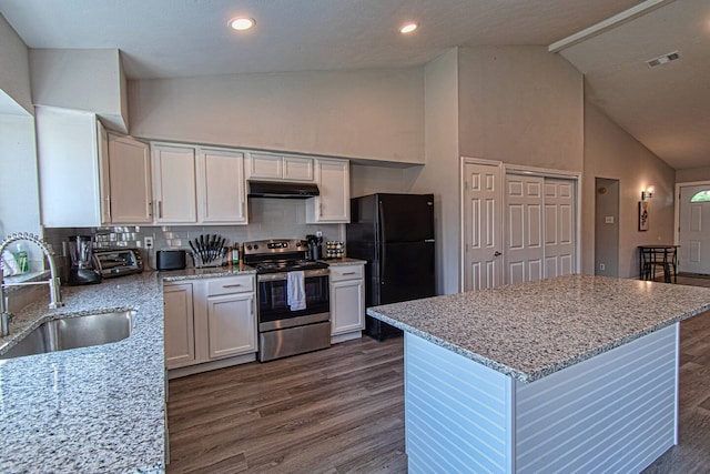 kitchen with white cabinetry, sink, tasteful backsplash, light stone counters, and stainless steel range with electric stovetop