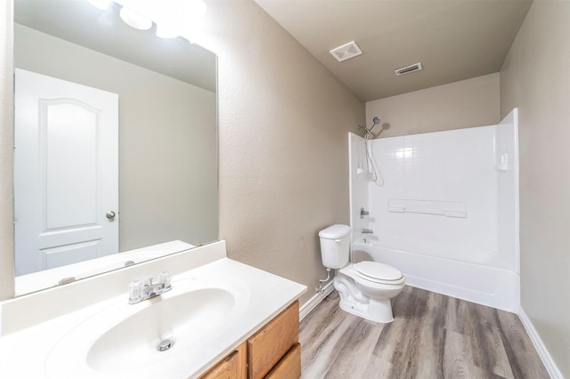 full bathroom featuring hardwood / wood-style flooring, vanity, toilet, and shower / bath combination