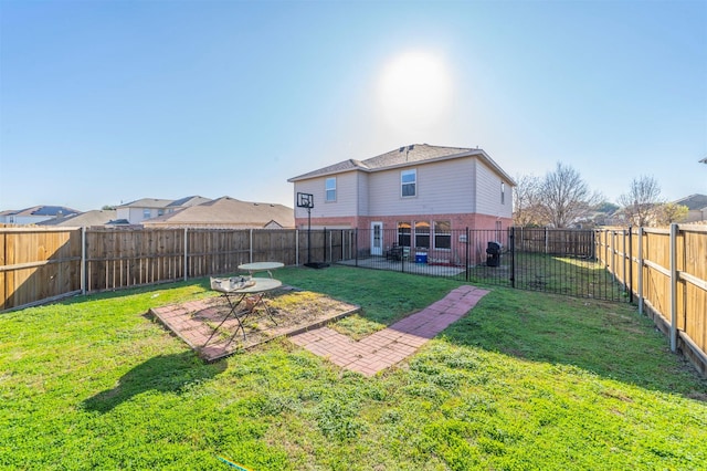 back of house with a yard and a patio area