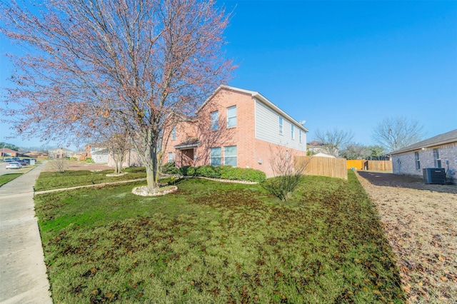 view of property exterior with a yard and central air condition unit