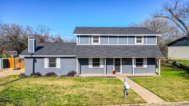 front facade with a patio and a front lawn