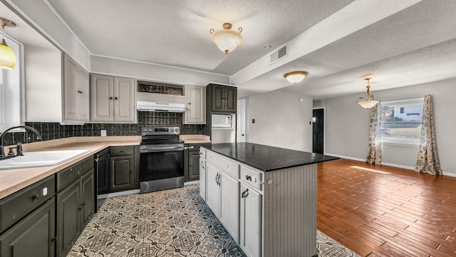 kitchen featuring sink, stainless steel electric range, gray cabinetry, a center island, and black dishwasher