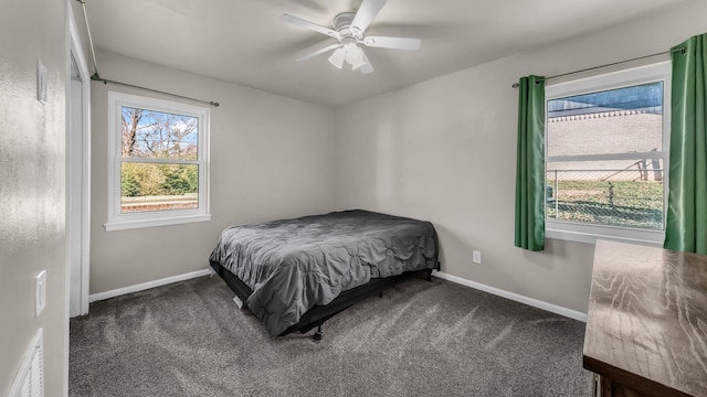 bedroom with ceiling fan and dark carpet