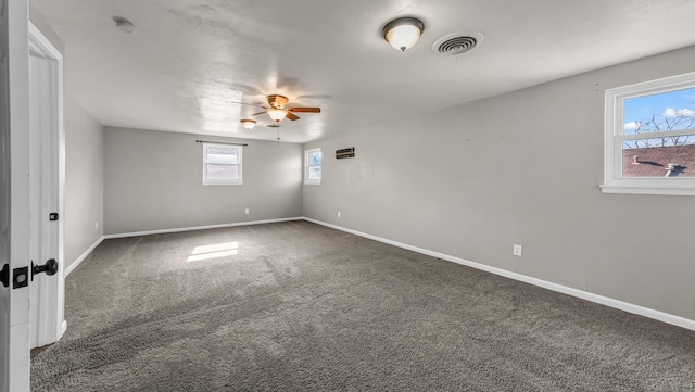 carpeted empty room featuring ceiling fan