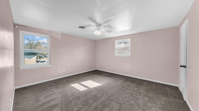 carpeted empty room featuring ceiling fan and a healthy amount of sunlight