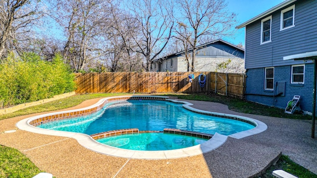 view of pool with an in ground hot tub