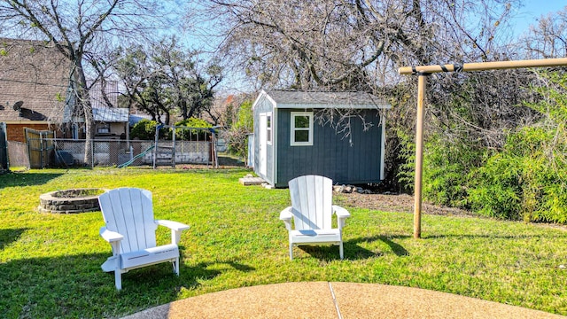 view of yard with a shed, a fire pit, and a playground