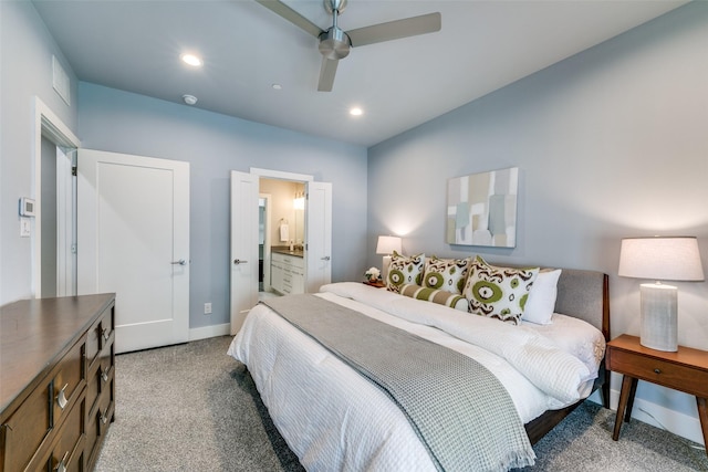 bedroom with ensuite bathroom, ceiling fan, and light carpet