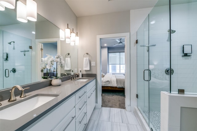 bathroom featuring ceiling fan, vanity, and a shower with shower door