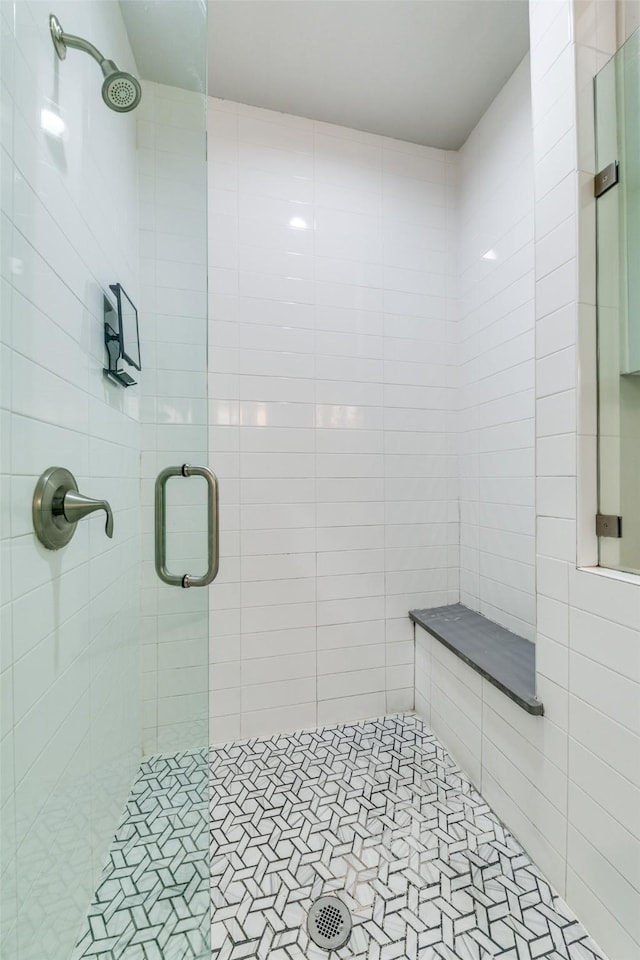 bathroom with tile patterned flooring and a shower with door