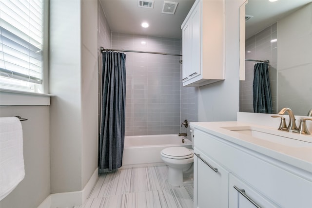 full bathroom featuring vanity, shower / bath combo, and toilet