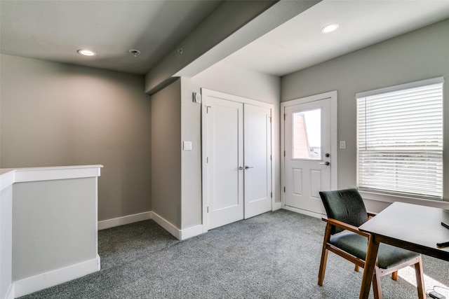 foyer entrance featuring carpet flooring