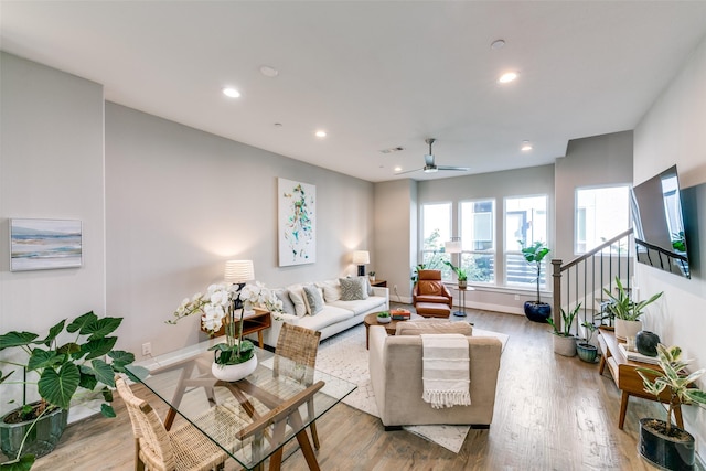 living room featuring ceiling fan and wood-type flooring