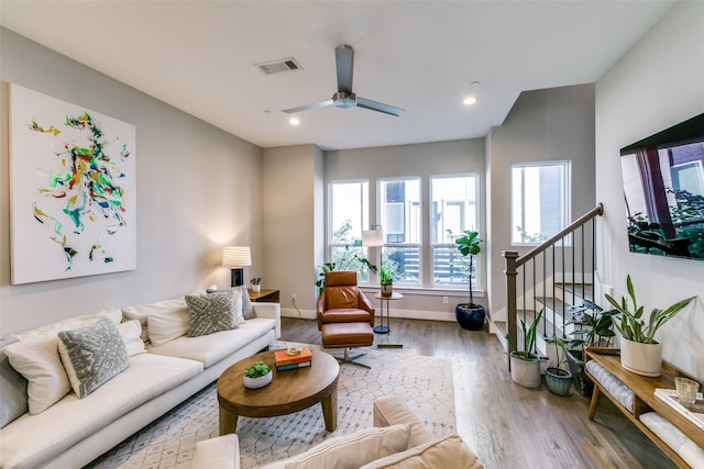 living room with ceiling fan and wood-type flooring