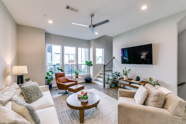 living room featuring ceiling fan and light wood-type flooring