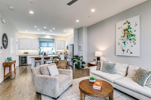 living room with light wood-type flooring and beverage cooler