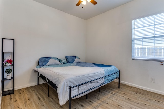 bedroom with ceiling fan and light hardwood / wood-style floors