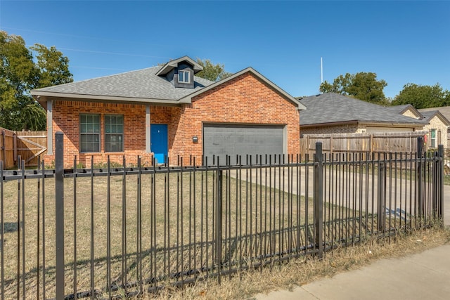 view of front of property featuring a front yard and a garage