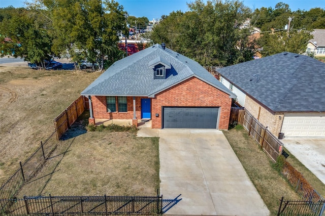 view of front of house featuring a front yard and a garage