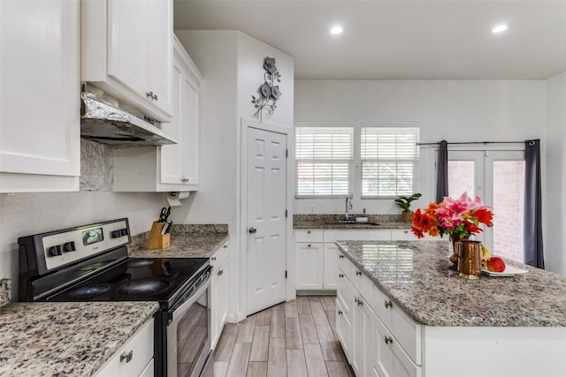 kitchen featuring light stone countertops, sink, light hardwood / wood-style flooring, stainless steel electric range, and white cabinets