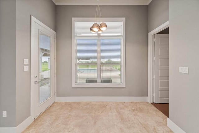 unfurnished dining area with baseboards, an inviting chandelier, and carpet flooring