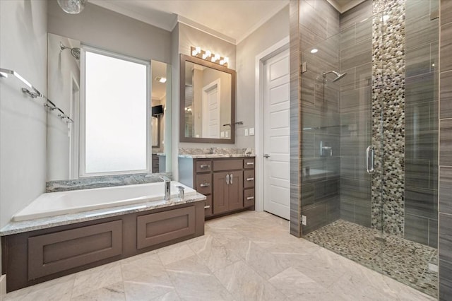bathroom with a garden tub, vanity, ornamental molding, and a stall shower